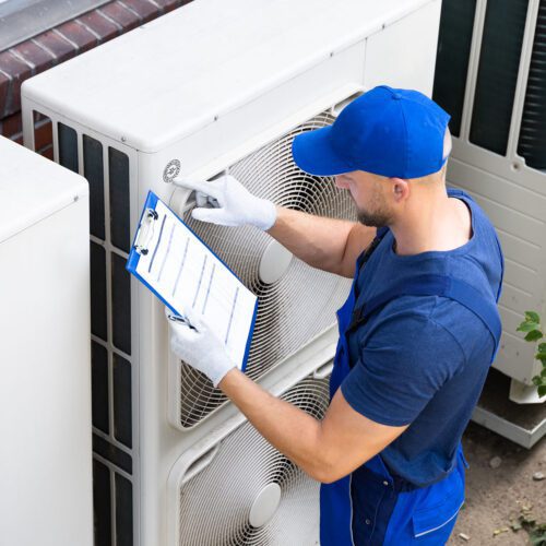 An Electrician Men Checking Air Conditioning Cooling Unit