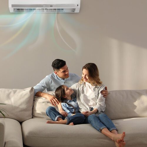 Happy family resting under air conditioner installed by Turner On HVAC services technicians in Cincinnati Ohio